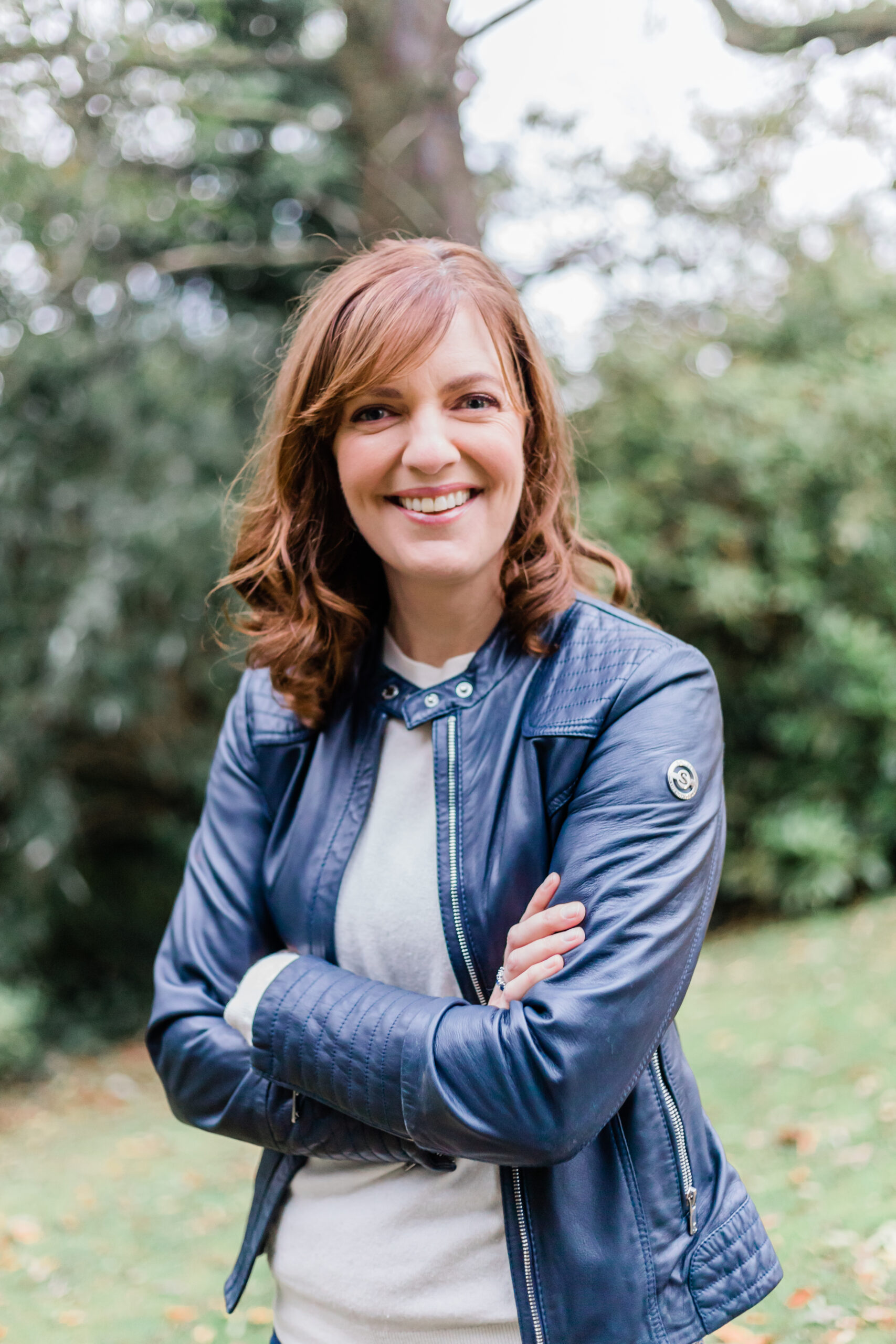 Sinead Doohan at The Happy Me sitting on a couch reading the book The Big Leap by Gay Hendrick